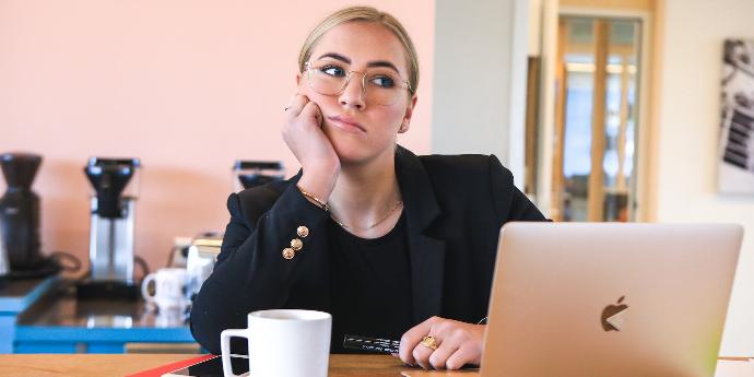 woman in black long sleeve shirt using macbook